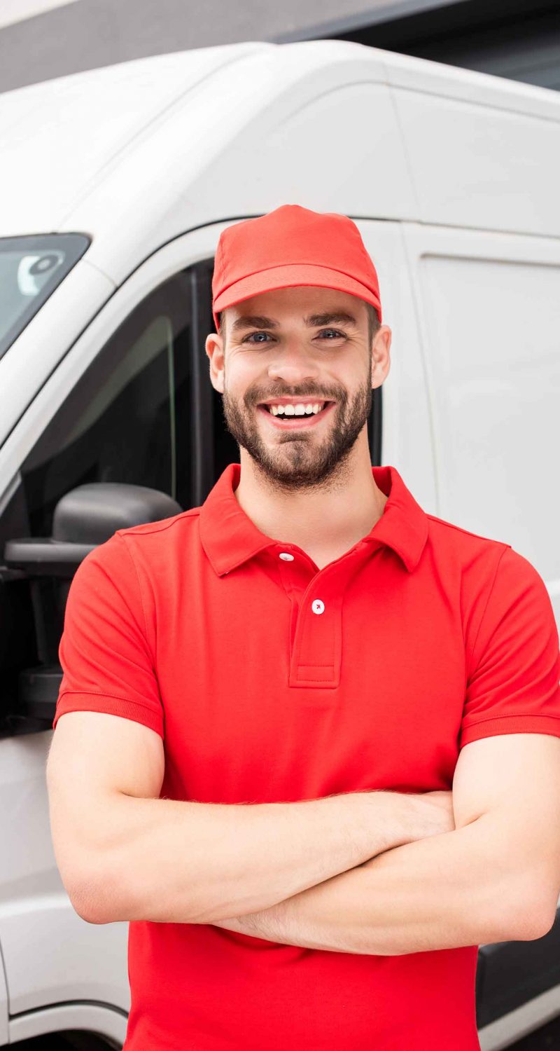 smiling-caucasian-delivery-man-standing-with-cross-MEFYCWG.jpg